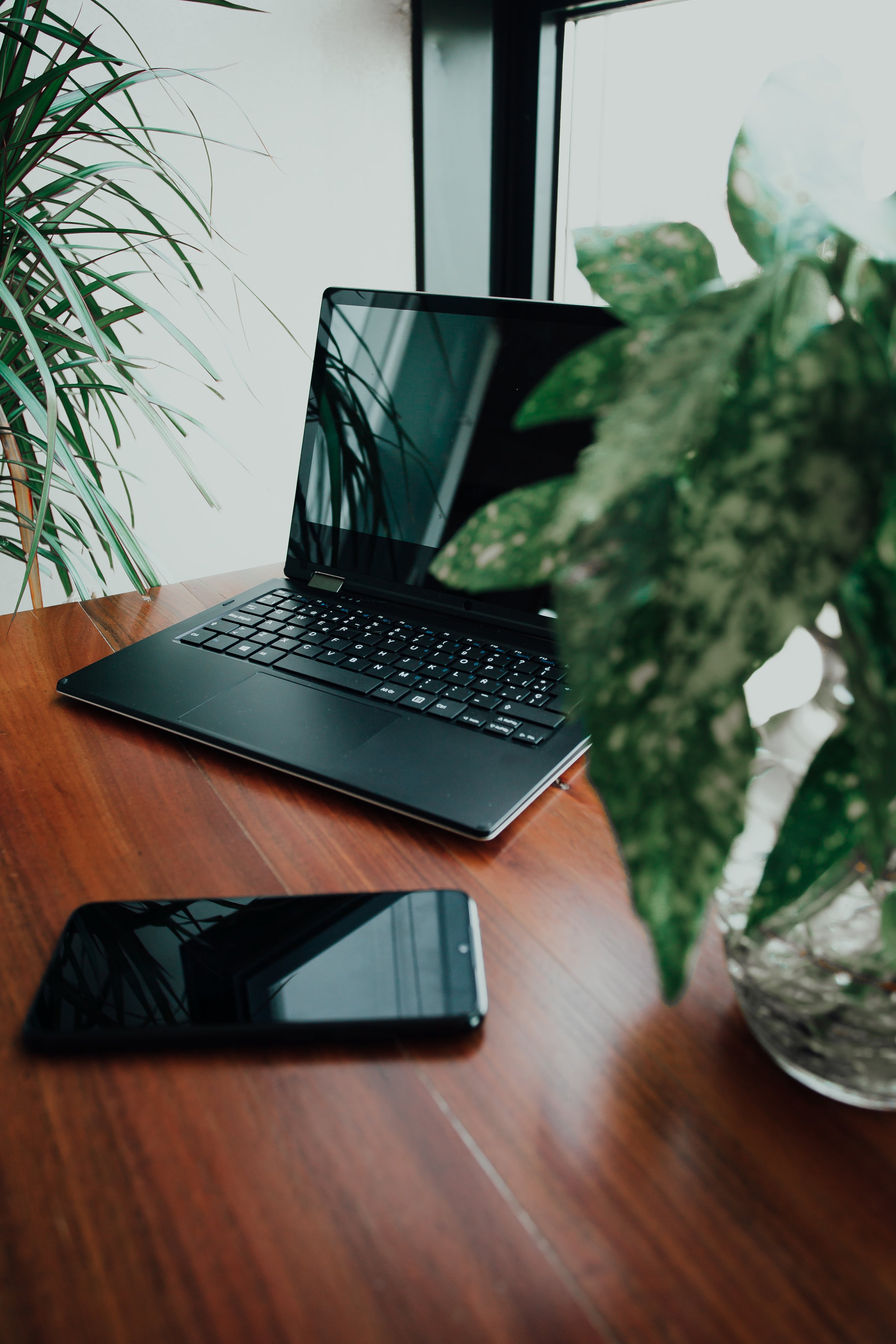 desk with laptop and phone